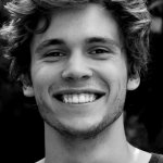 Lachender junger Mann mit gesunden Zähnen – Symbolbild Zahnarzt 1060 Wien